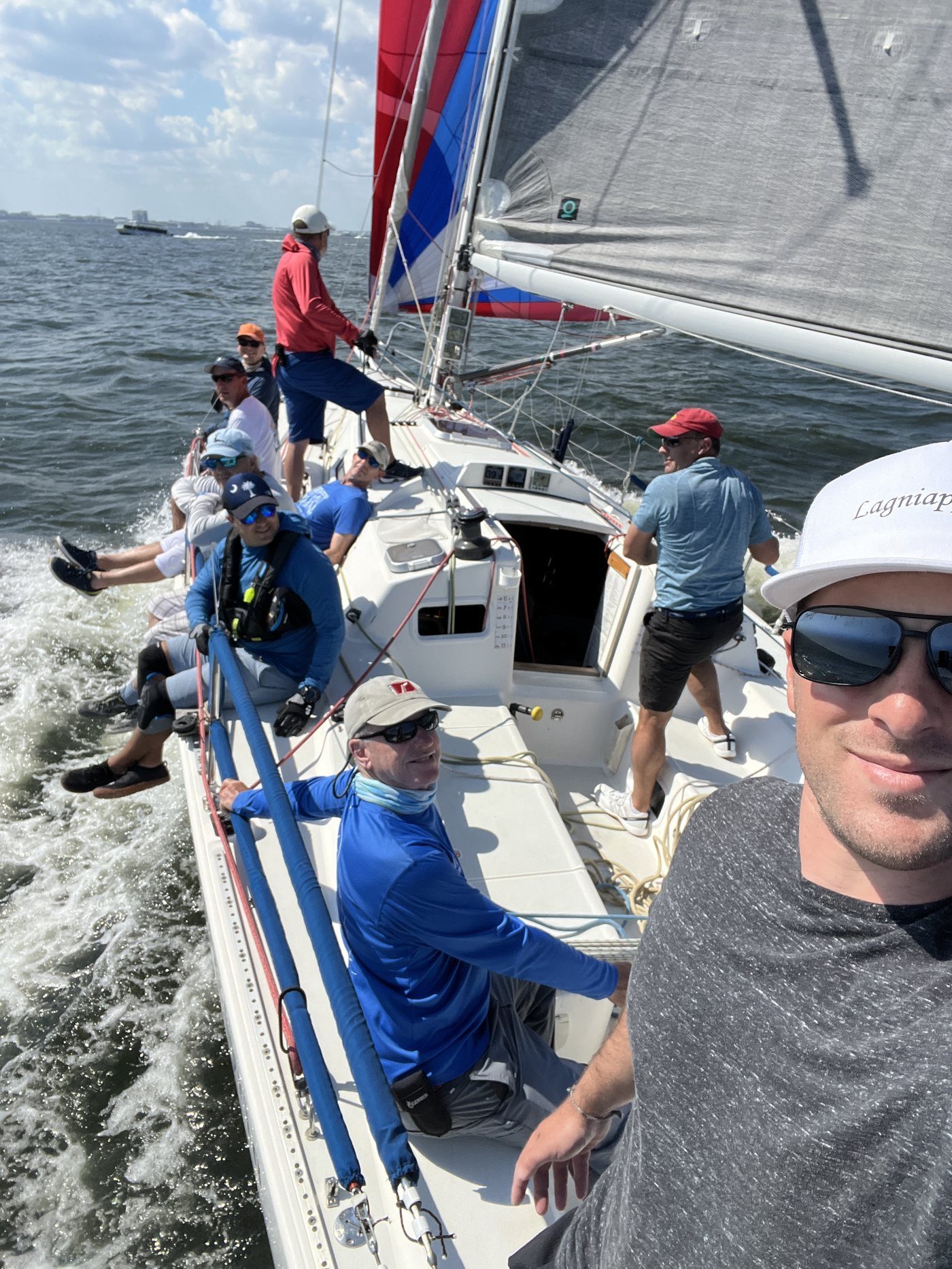 Ten sailors hiking on the rail of a J/105.