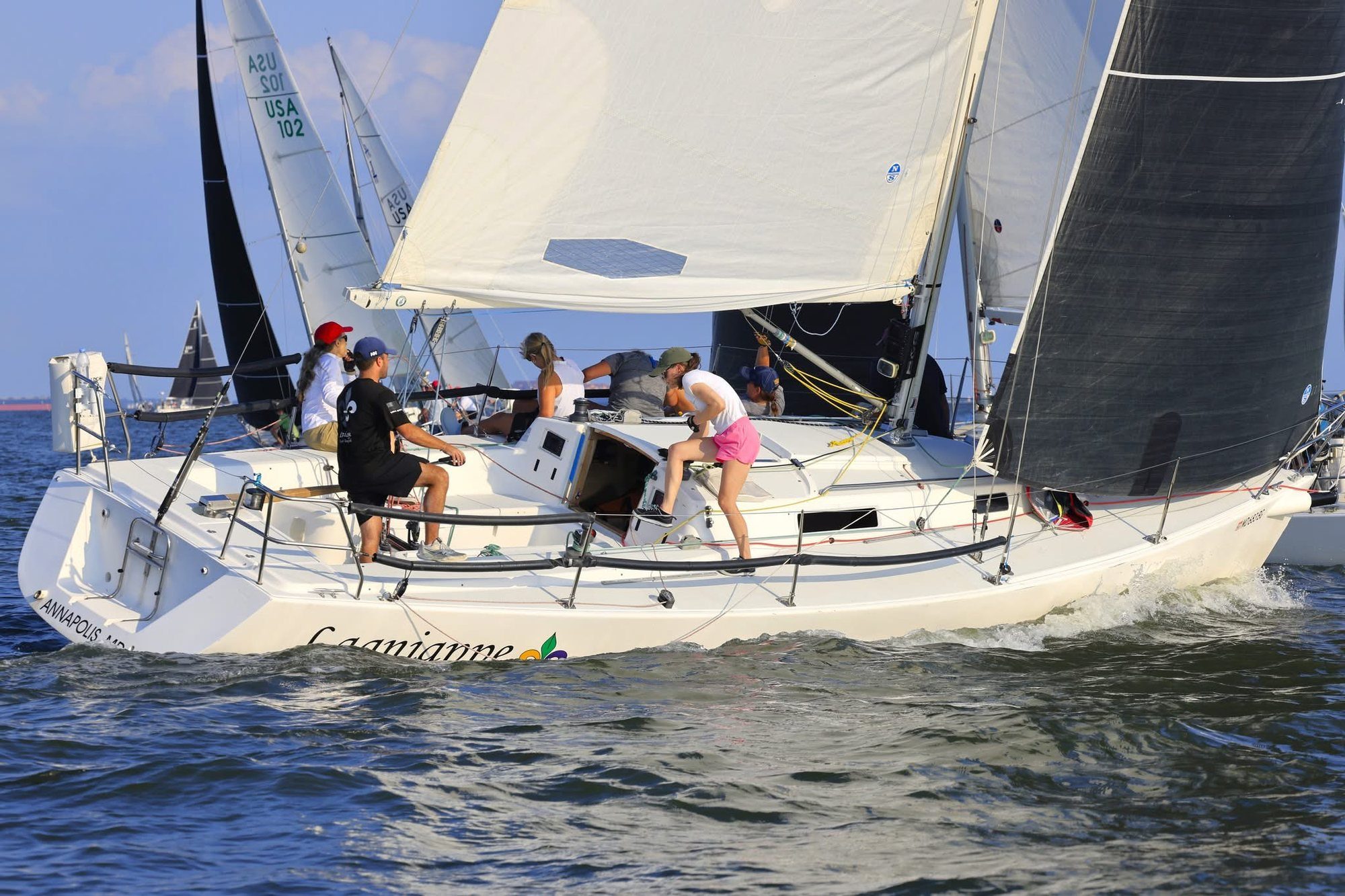 A crew racing a J/105 on the Chesapeake Bay, every person working.
